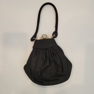 Vintage black peau de soie clutch opera bag with soft wrist strap.